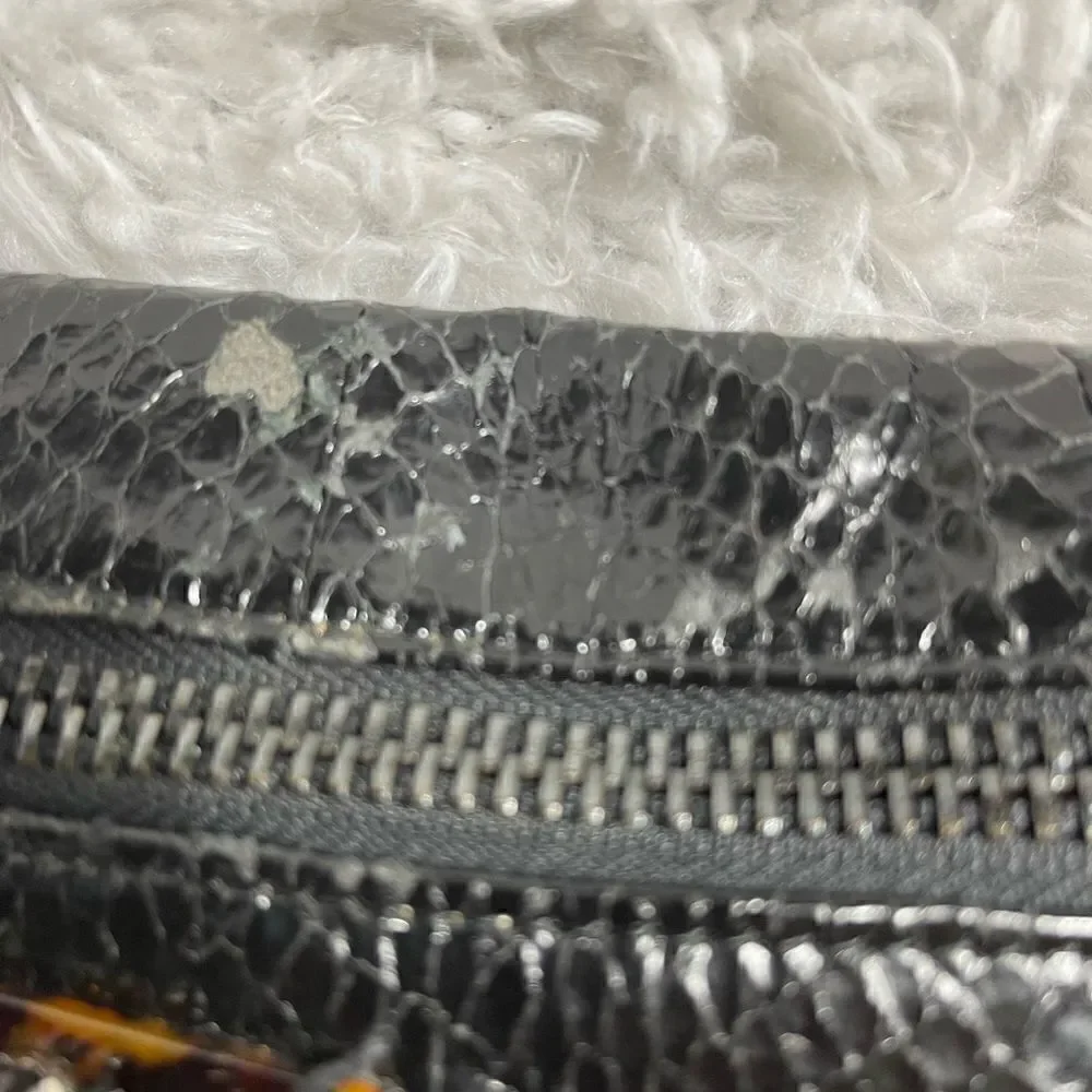 Rafe Black patent snake skin print clutch embellished with jewels and tassel .
